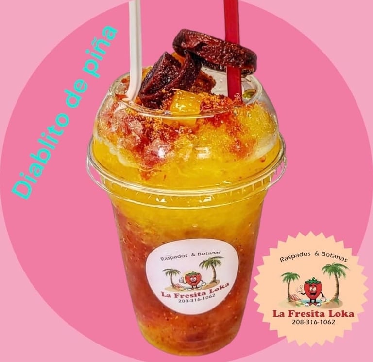 Tropical iced beverage in clear plastic cup with red straw, topped with red candy bow, on pink background with La Fresita Loka logo