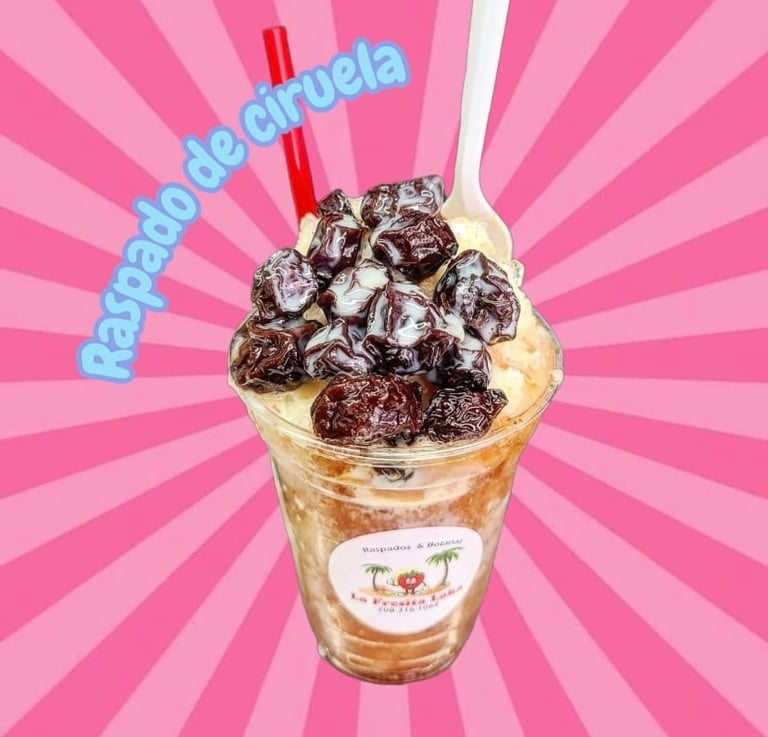Iced beverage with chocolate toppings and red straws on pink sunburst background, labeled Rapado de Ciruela