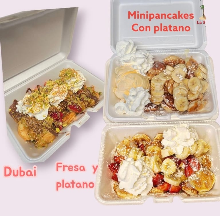 Three takeout containers of gourmet mini pancakes topped with whipped cream, berries, and caramel sauce on a pink background