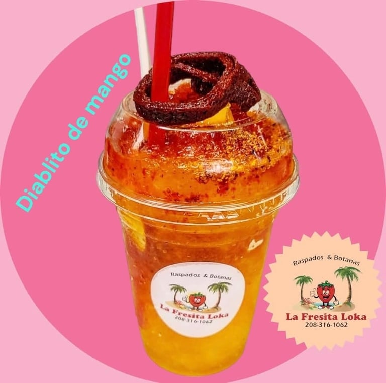 A colorful tropical drink in a clear cup with a chocolate brownie on top, set against a pink background with Spanish text and a La Fresita Loka logo