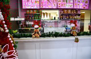 Holiday-decorated toy store counter with stuffed animals and Christmas decorations