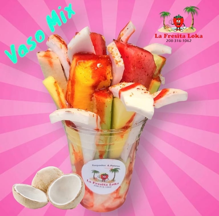 Vaso Mix beverage with fresh fruit slices including mango, pineapple, apple, and coconut pieces in a pink cup with radiant background